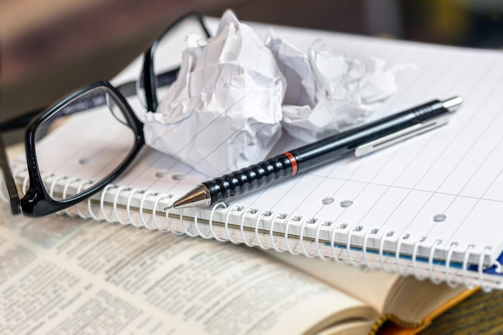 a book and notebook with a crumpled page, indicating frustration with a deal breaker.