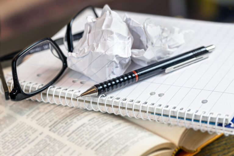 a book and notebook with a crumpled page, indicating frustration with a deal breaker.