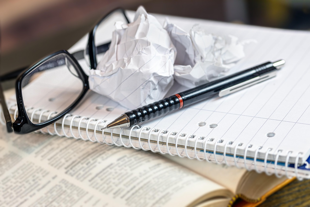 a book and notebook with a crumpled page, indicating frustration with a deal breaker.