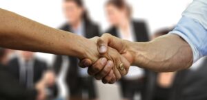 Business Acquisition partners shaking hands.