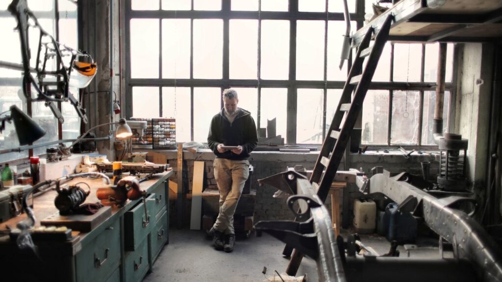 Business owner standing in his workshop, representing finding a small business to buy