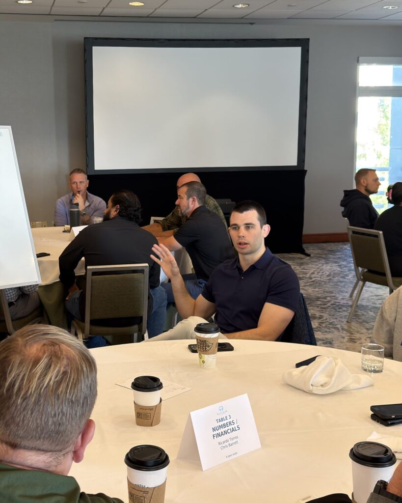 Chris Barrett, CPA, discussing financials with business buyers at a roundtable session