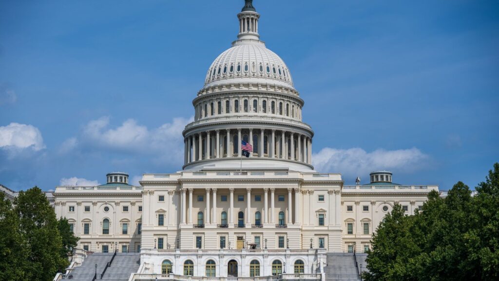 The United States Capitol building in Washington, D.C. under a blue sky
